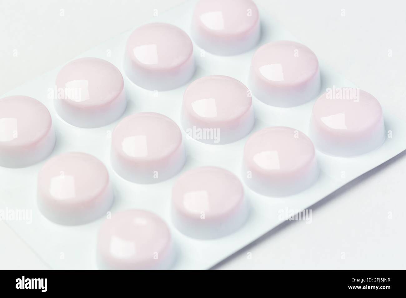 Close up of pills in white plastic blister pack Stock Photo