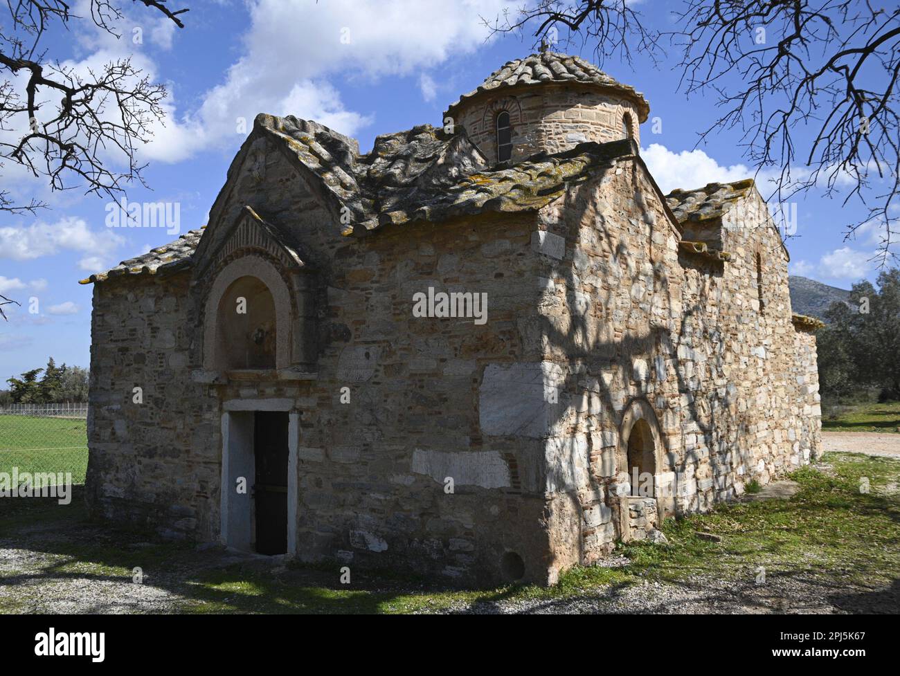 Landscape with scenic exterior view of Aghios Petros a 12th century rectangular cruciform Byzantine church in Kalyvia Thorikou, Attica Greece. Stock Photo