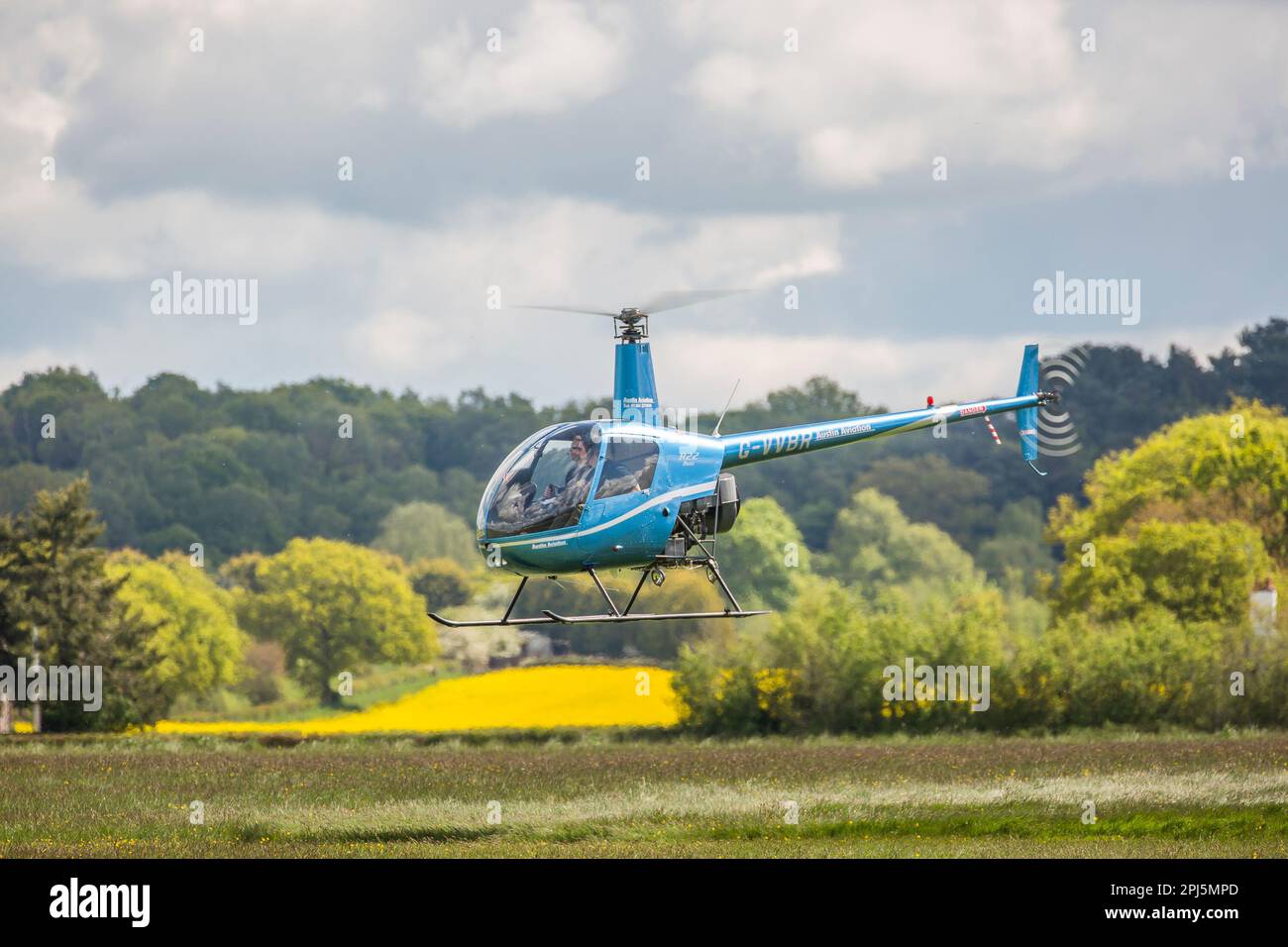 Aviation tuition: blue helicopter flying isolated at Halfpenny Green Airport, nr. Wolverhampton, West Midlands, UK. Stock Photo