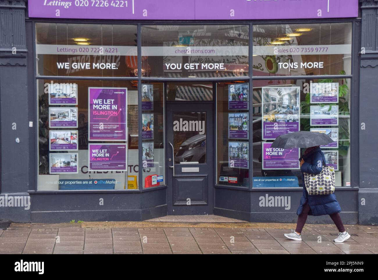 London, England, UK. 31st Mar, 2023. A woman walks past an estate agent