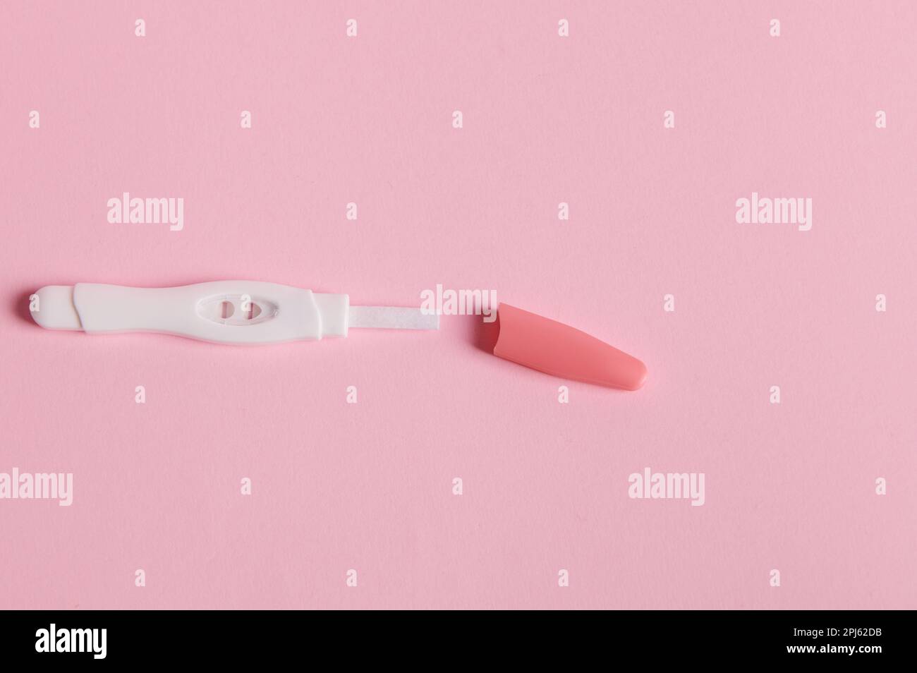Flat lay with a pregnancy test showing positive result between HCG