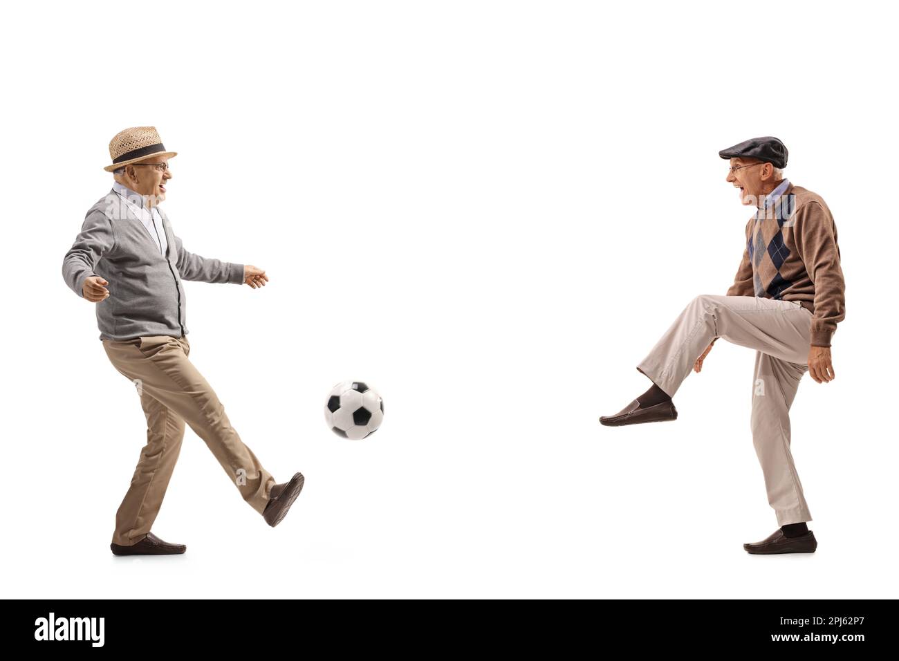 Full length profile shot of two senior men playing football isolated on