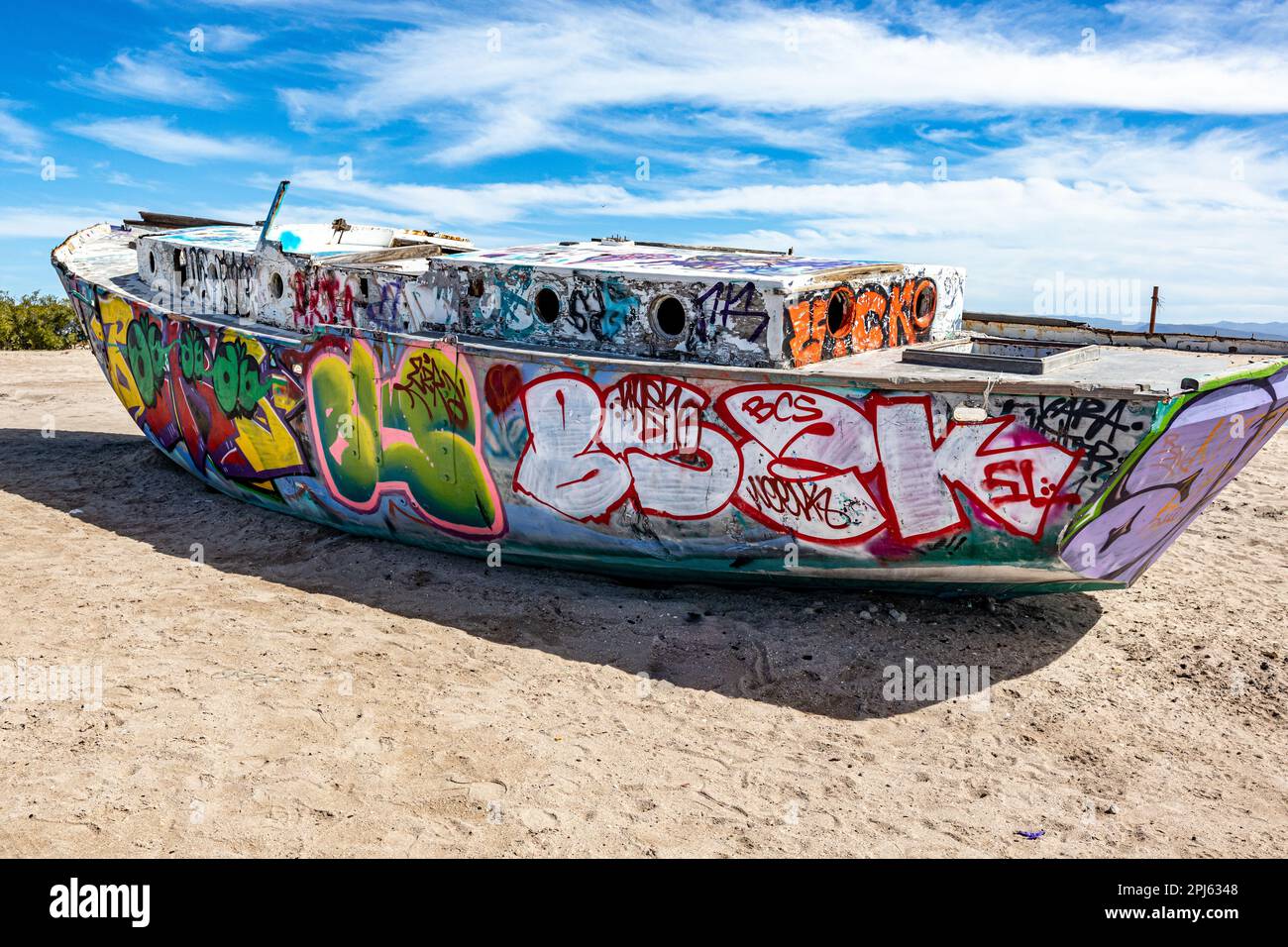 La Paz, Baja California Sur Mexico. 9 February, 2023. Old stranded ship painted with graffiti in Playa el Centenario or Comitan against a blue sky and Stock Photo