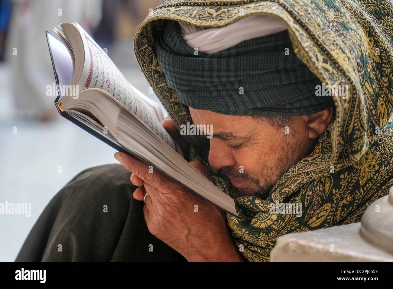 A muslim reads the Islamic holy book "Quran", during the Muslims holy ...
