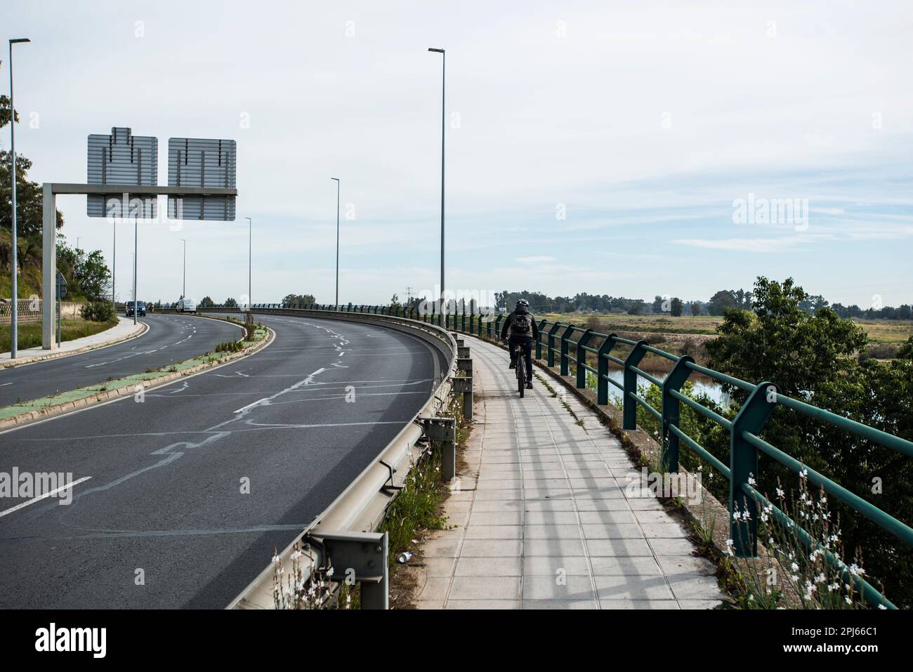 Man riding a bike on a road in Badajoz Stock Photo