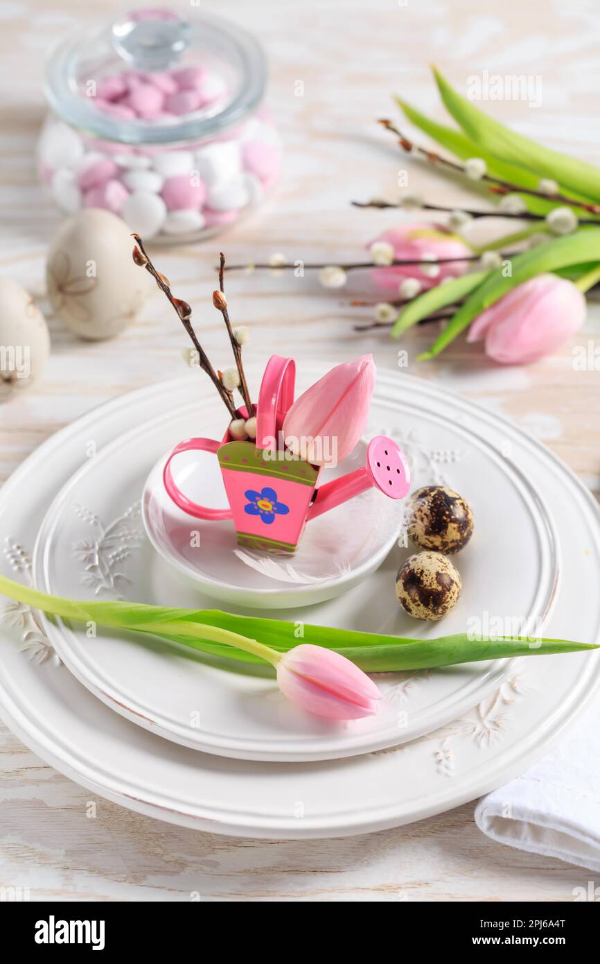 Place setting for Easter table with spring flowers. Easter table decoration Stock Photo