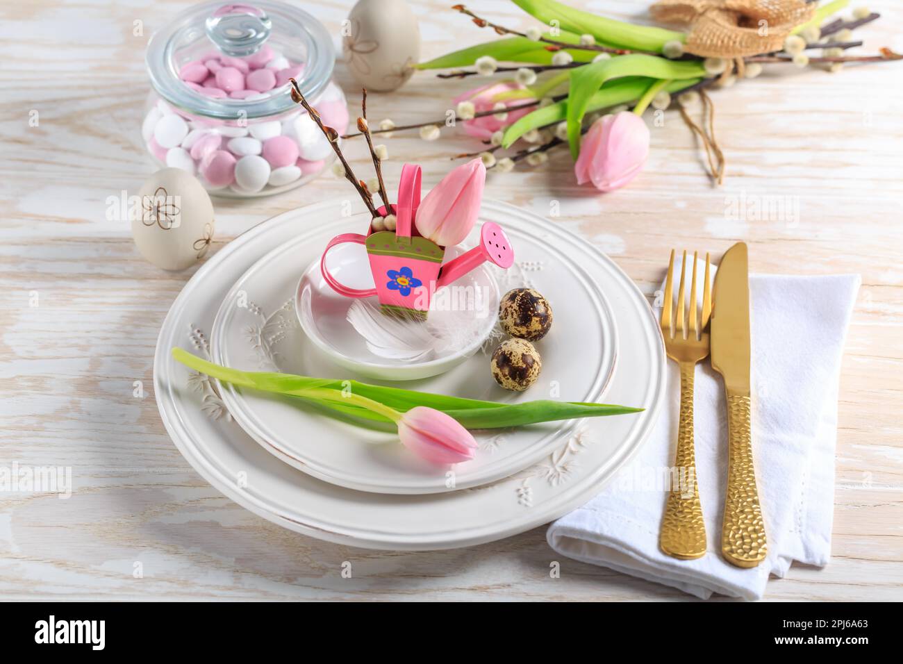 Place setting for Easter table with spring flowers. Easter table decoration Stock Photo