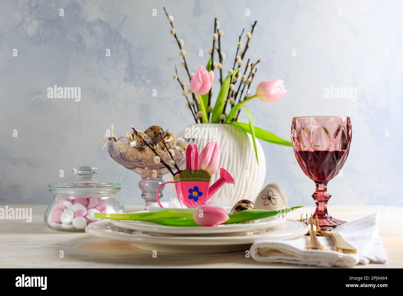 Place setting for Easter table with spring flowers. Easter table decoration Stock Photo