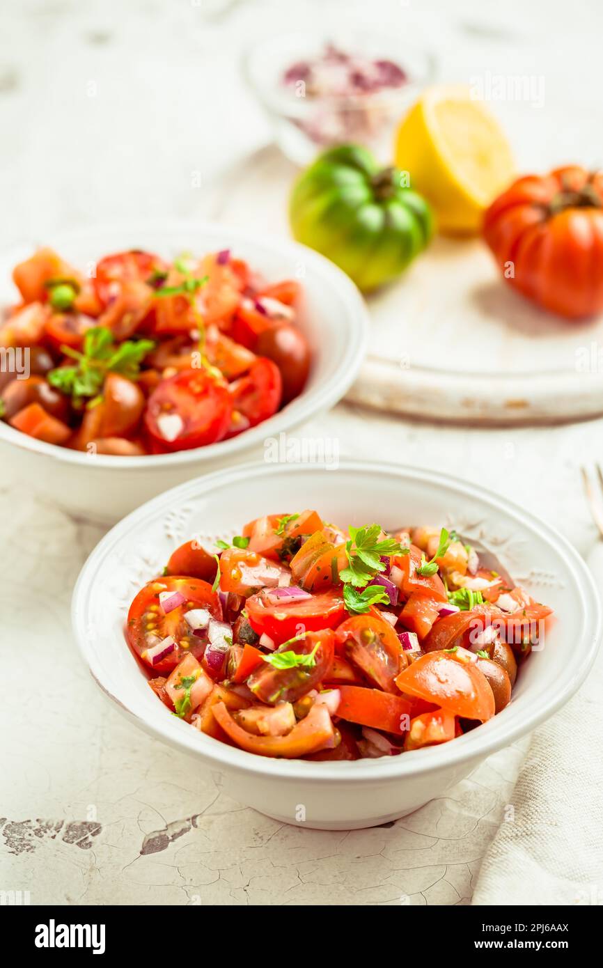 Mexican Pico de Gallo with ingredients - tomato salad, Mexica salsa with onion, parsley, coriander and lemon Stock Photo