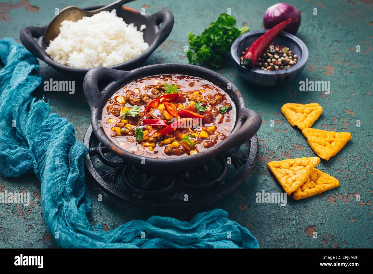 Hot Mexican Chili con carne with rice and tortilla chips and spices