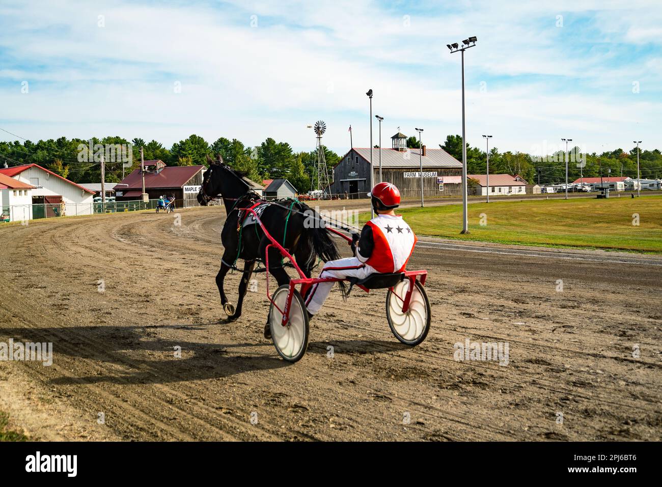 Jockey and horse. Trotting horse race. Race in harness with a sulky or
