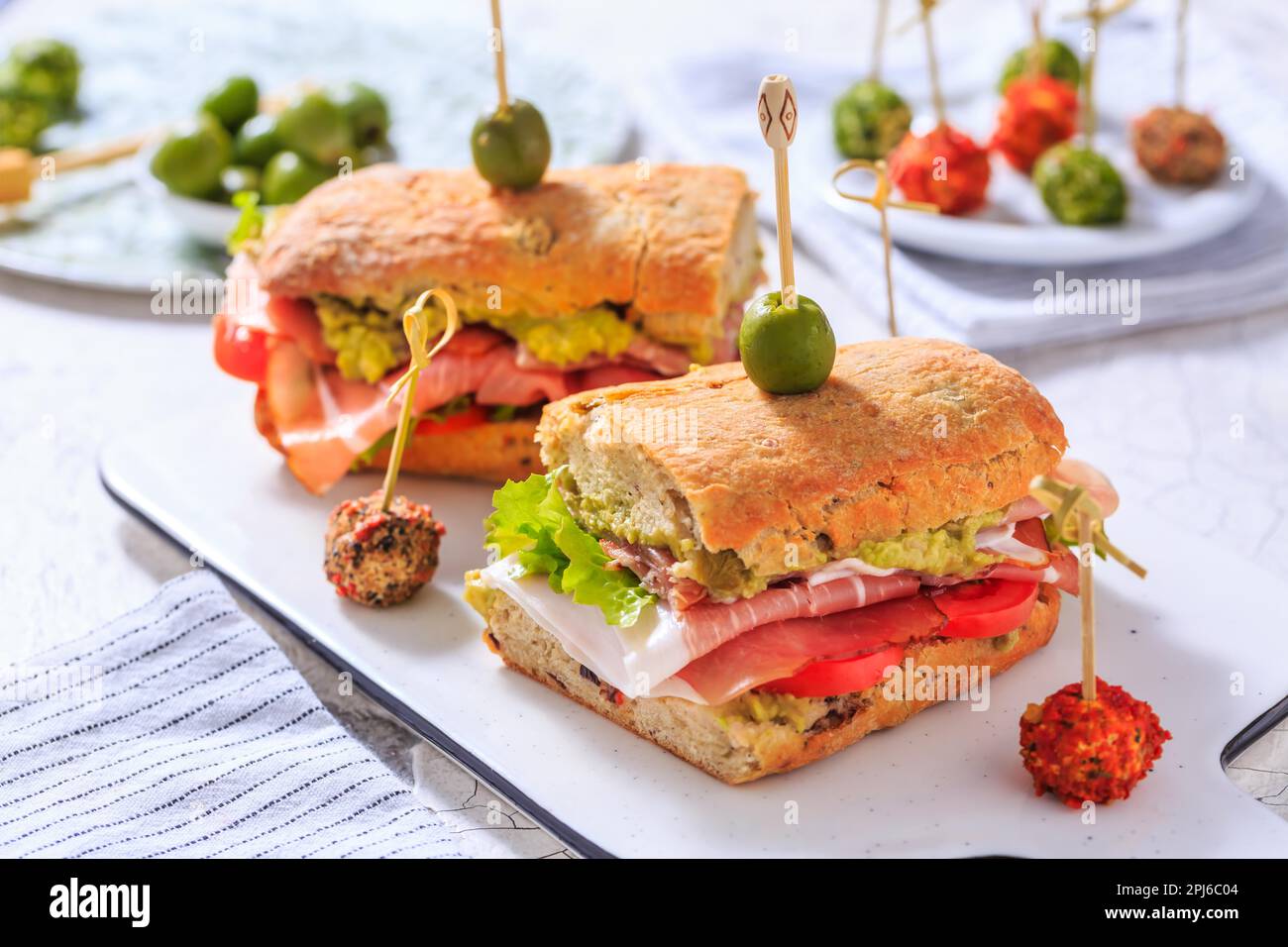 Homemade Ciabatta sandwich with guacamole, prosciutto, lettuce and