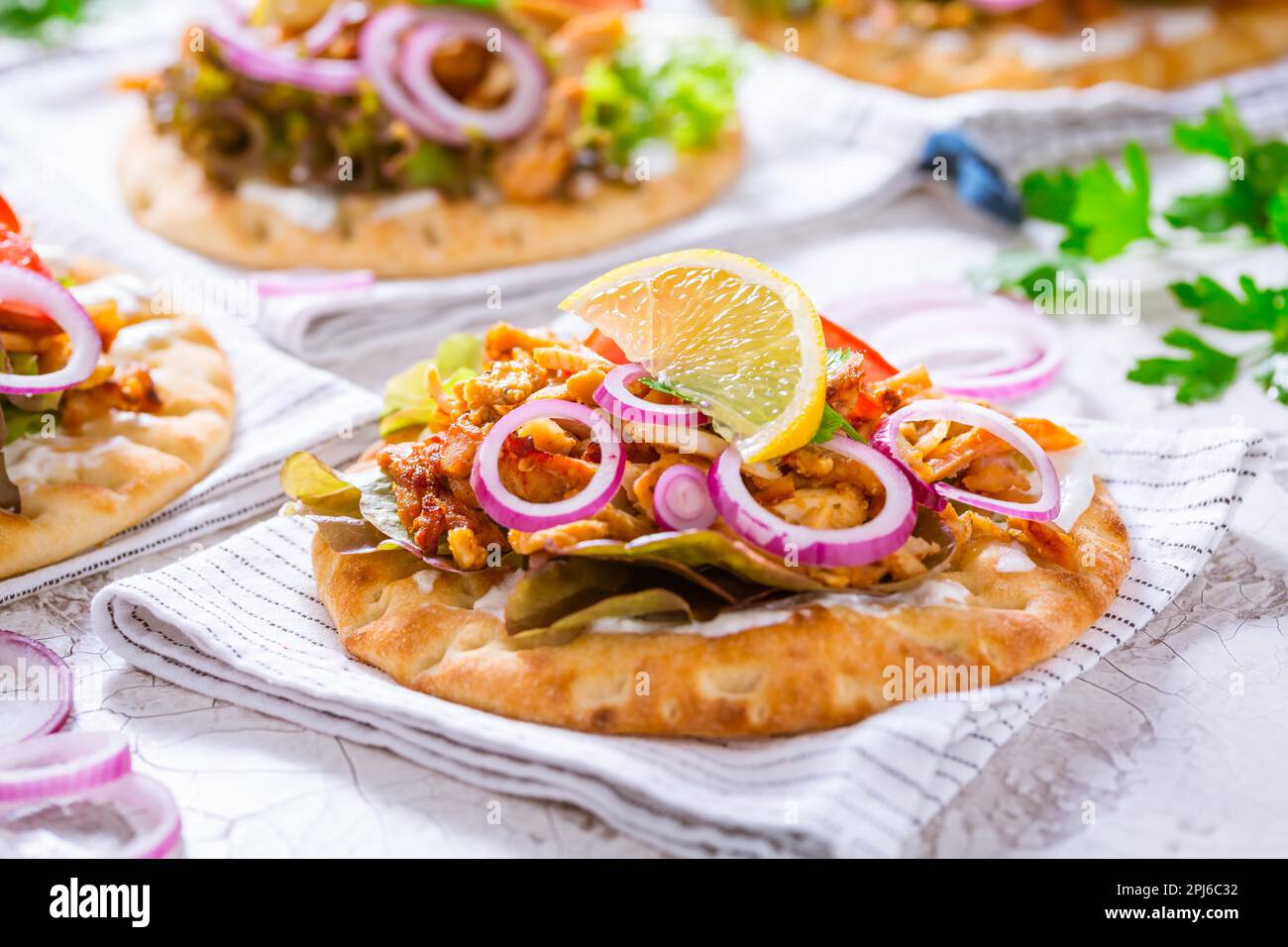 Greek gyros meat with pita flat bread, vegetables and onions and