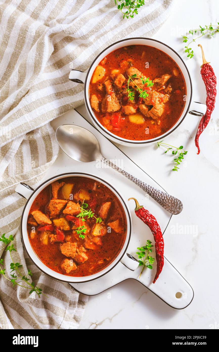 Beef goulash soup hearty Hungarian soup of meat and vegetables seasoned with paprika on white