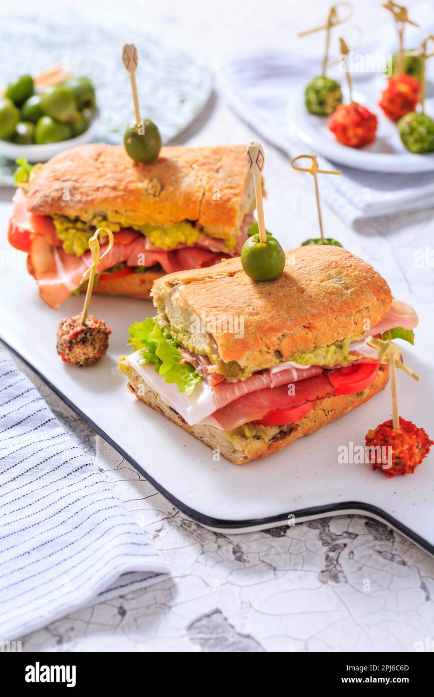 Homemade Ciabatta sandwich with guacamole, prosciutto, lettuce and