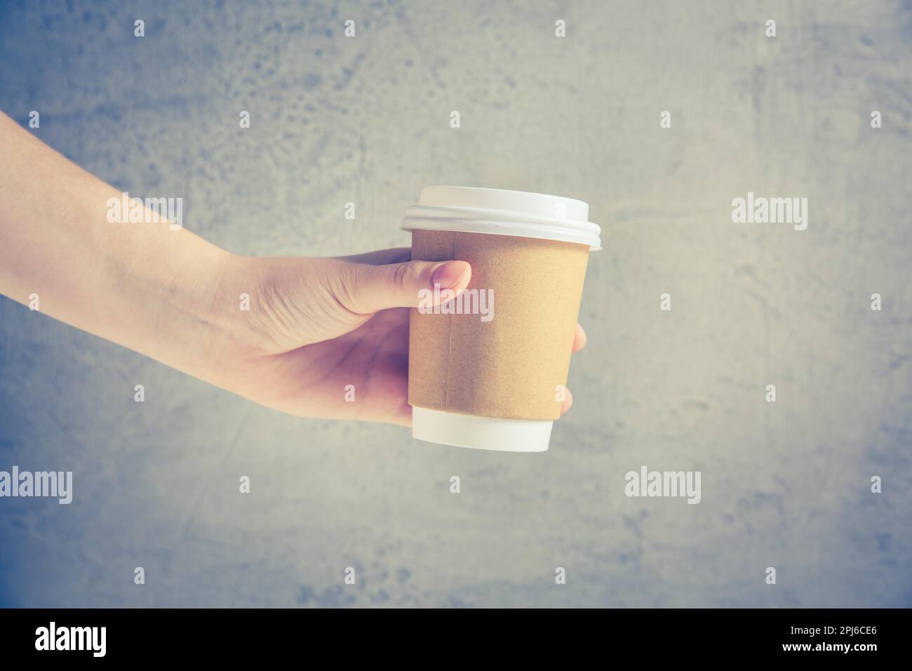 Hand holding disposable coffee cup Stock Photo Alamy