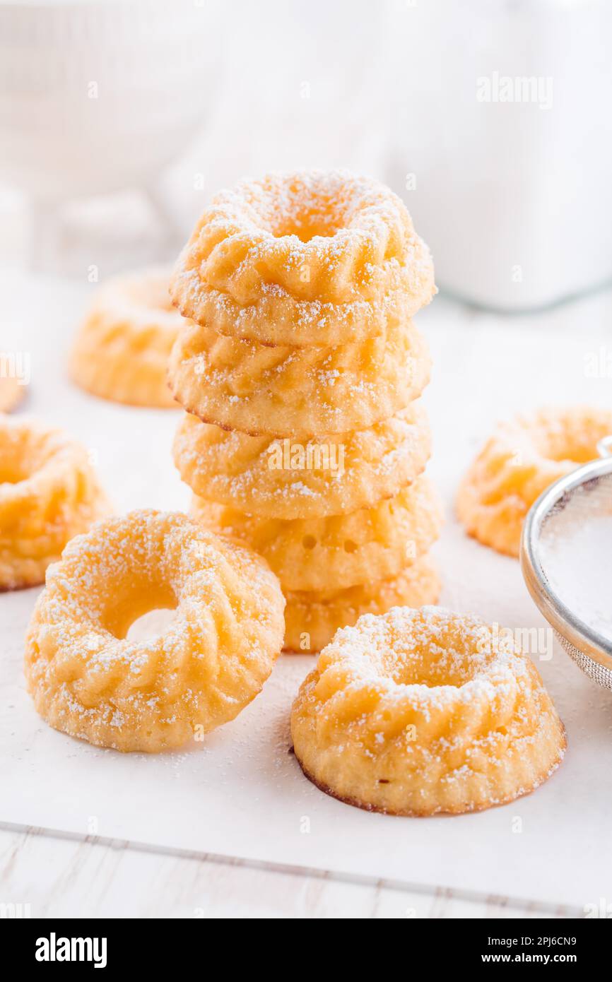 Small sponge cakes with cottage cheese. Ring cakes on white background