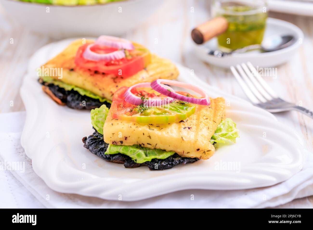 Portobello mushroom open sandwich or burger with grilled halloumi