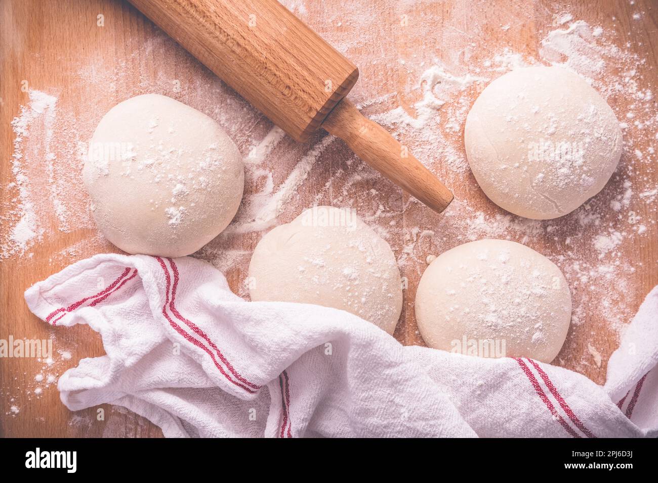 Yeast dough for making braided cakes, pies, pizza and rolls with rolling pin. Preparing leavened
