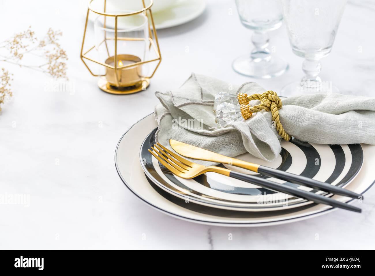 Image of cutlery sets with plate, cup and candle. Party theme, place and table setting Stock Photo
