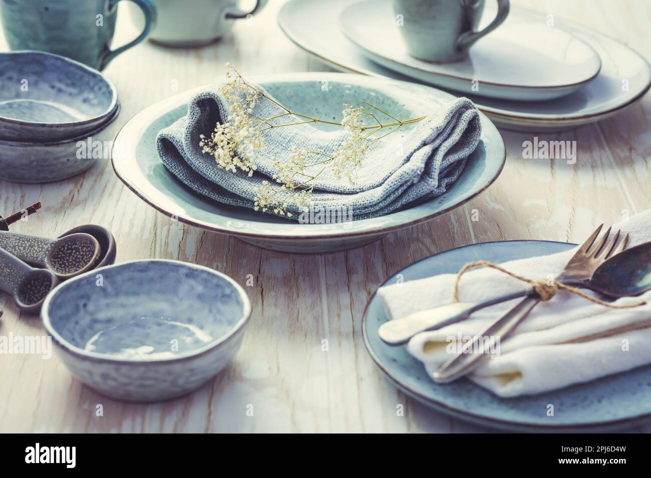 Stoneware kitchen utensils sustainability. Assortment of plates, bowls and cups from natural