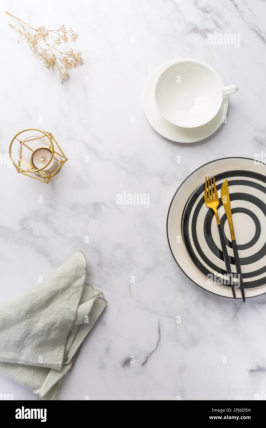 Image of cutlery sets with plate, cup and candle. Party theme, place and table setting Stock Photo