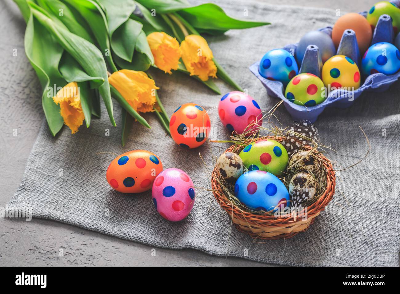 Spring time - Easter eggs and tulips on grey background Stock Photo