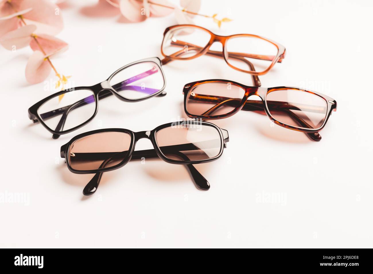 Several trendy stylish glasses on white background with copy space