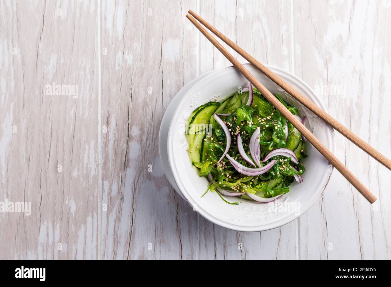Traditional Japanese Sunomono salad with cucumber and wakame seaweed and sesame seeds Stock Photo