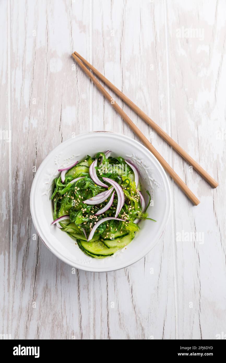 Traditional Japanese Sunomono salad with cucumber and wakame seaweed and sesame seeds Stock Photo