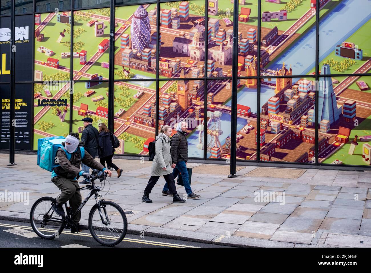 Passers by interact with a large scale computer game illustration of