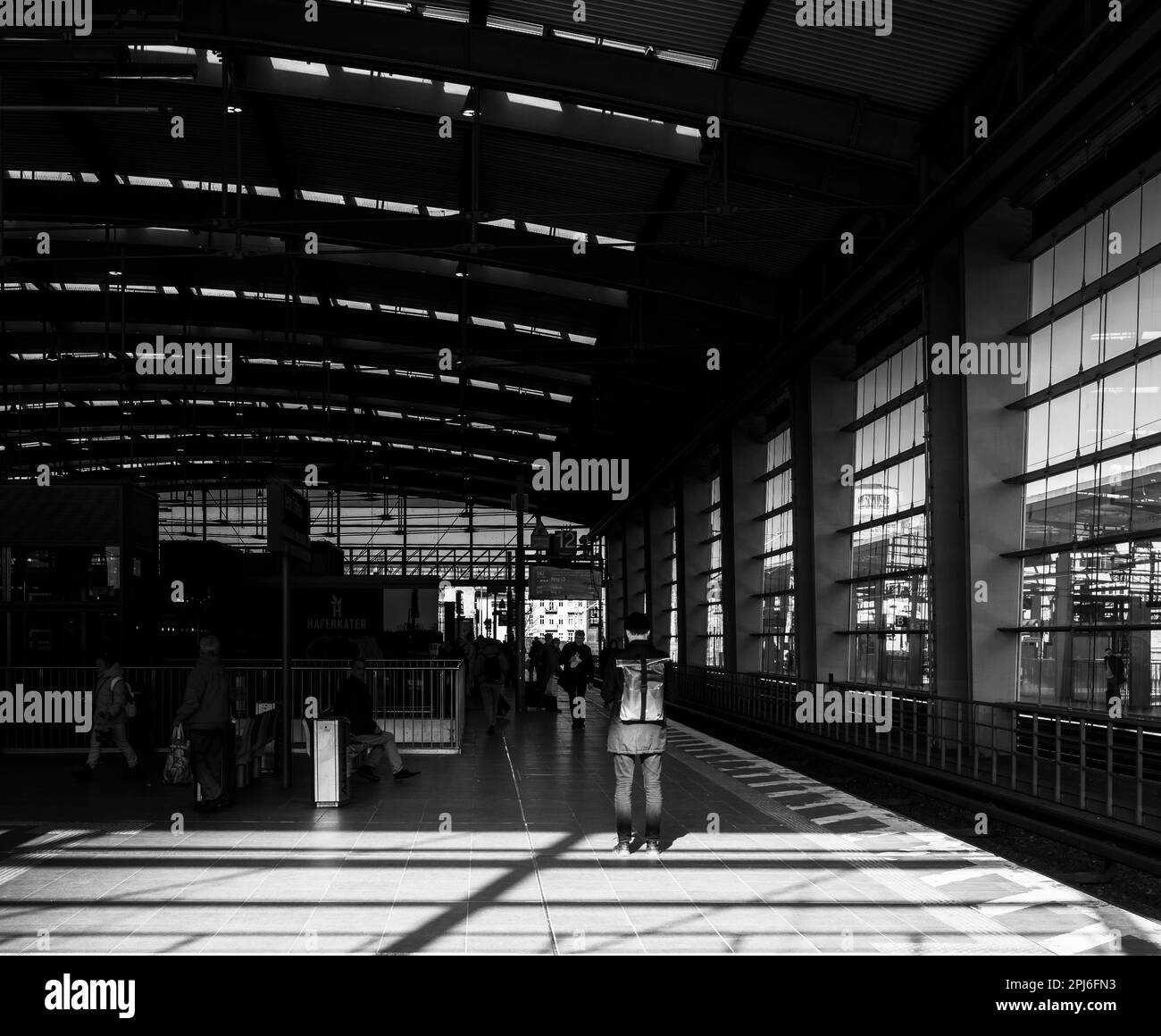 Black and white photograph, travellers at Ostkreuz station
