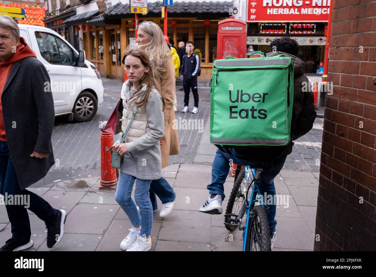 Uber Eats takeaway delivery cycle courier on 30th March 2023 in London, United Kingdom. Uber Eats is an online food ordering and delivery platform launched by Uber in 2014. It acts as an intermediary between independent takeaway food outlets and customers, with thousands of cycle couriers delivering food by bicycle and other forms of transport. Gig workers are independent contractors, online platform workers, contract firm workers, on-call workers and temporary workers. Gig workers enter into formal agreements with on-demand companies to provide services to the companys clients. Stock Photo