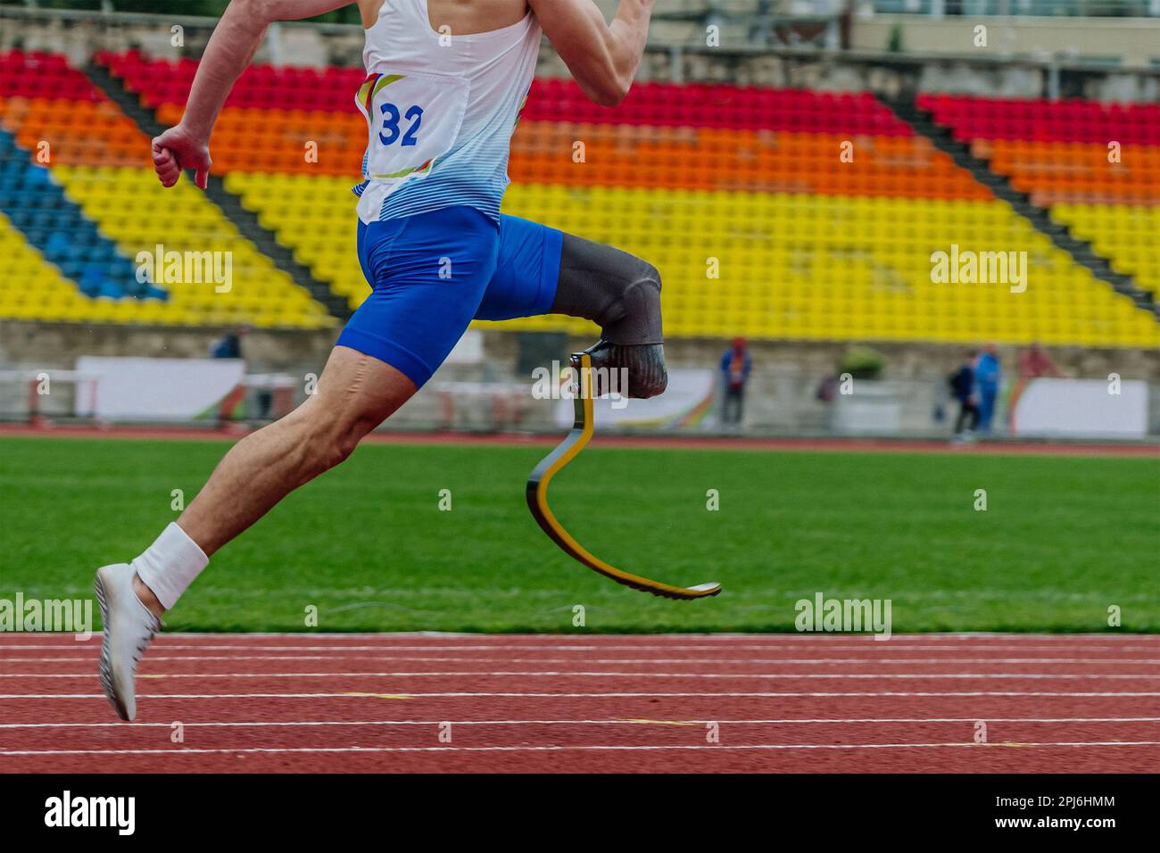close-up legs athlete runner on prosthesis running stadium track, disabled athlete para athletics competition, summer sports games Stock Photo