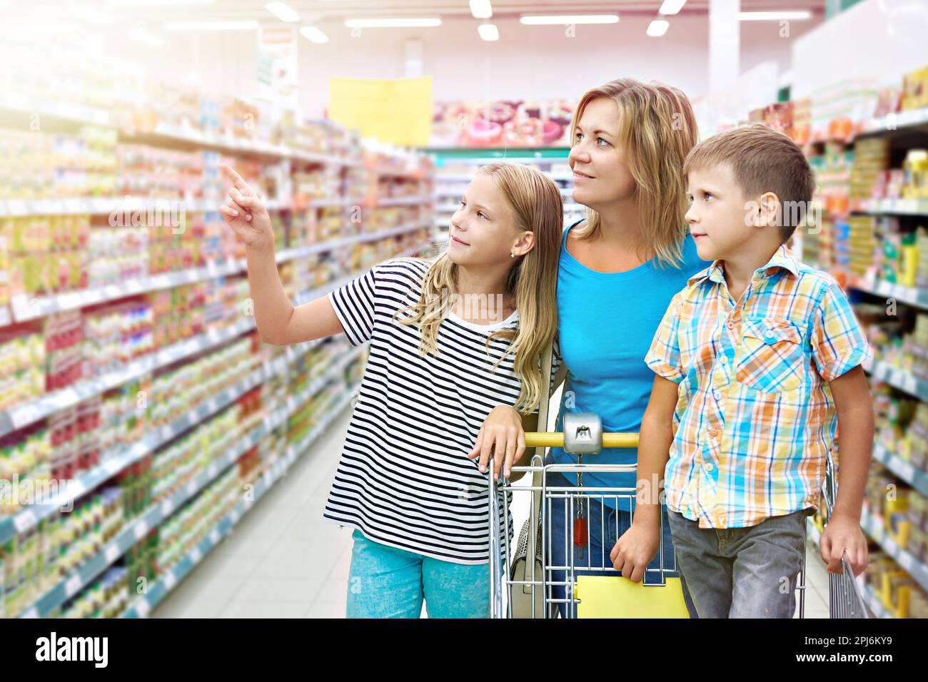Mother and children are choosing products in shop Stock Photo