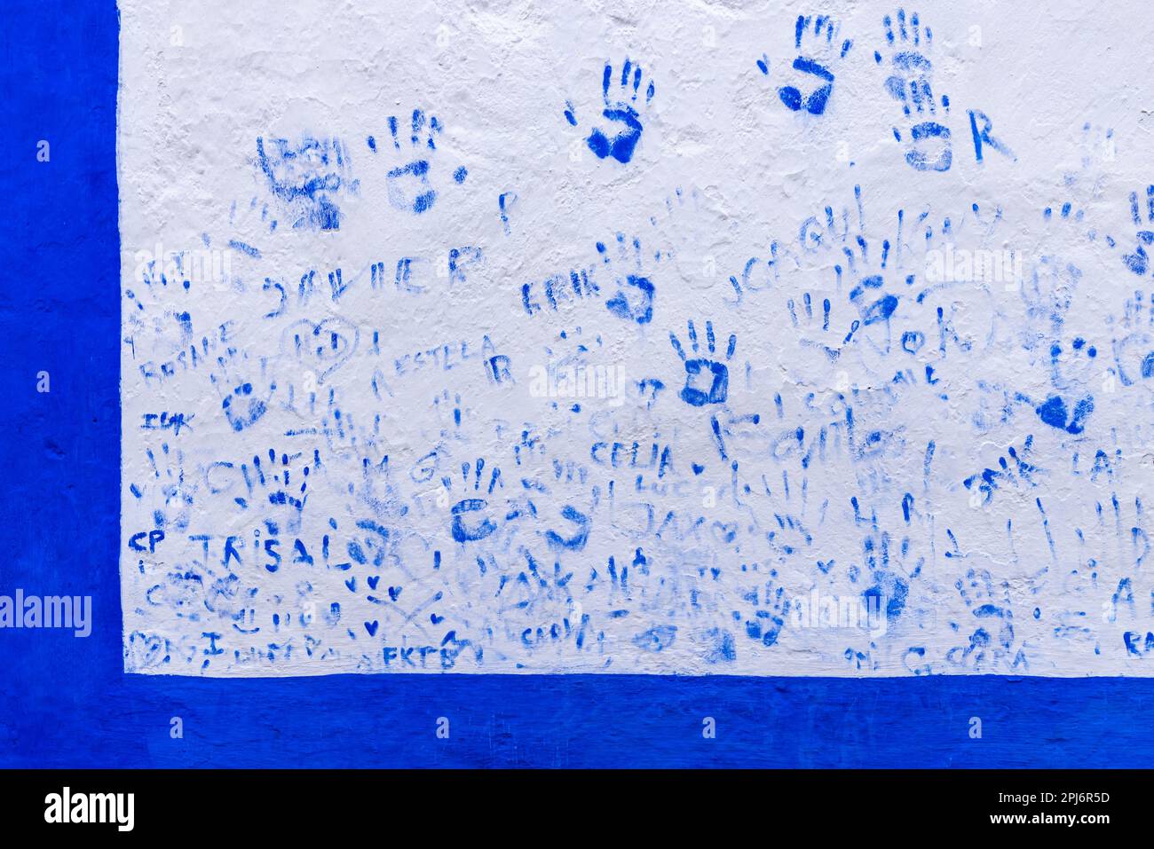 Europe, Portugal, Obidos. April 15, 2022. Blue graffiti of hand prints and names on a wall in Obidos. Stock Photo