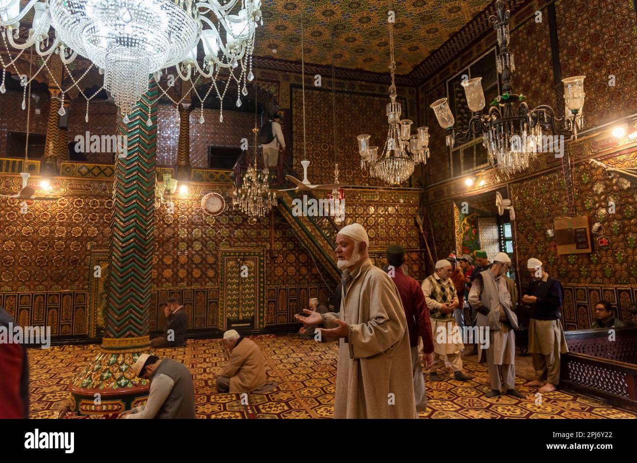 A Kashmiri Muslim man raises his hands as he prays inside a shrine on ...