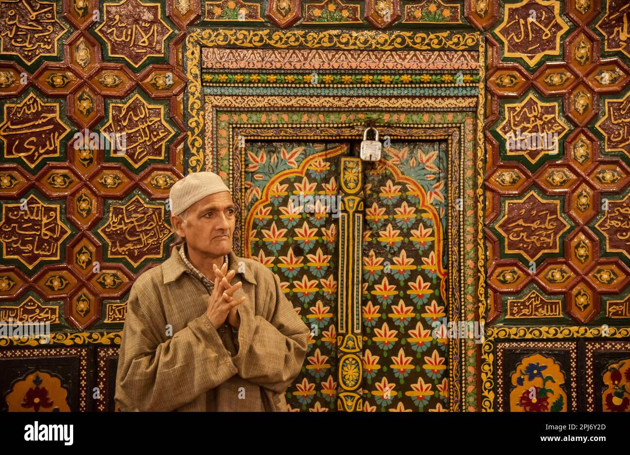 A Kashmiri Muslim man raises his hands as he prays inside a shrine on ...