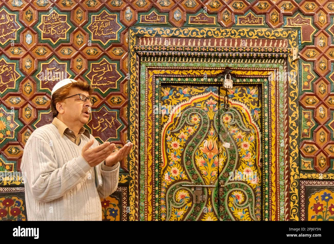 A Kashmiri Muslim man raises his hands as he prays inside a shrine on ...