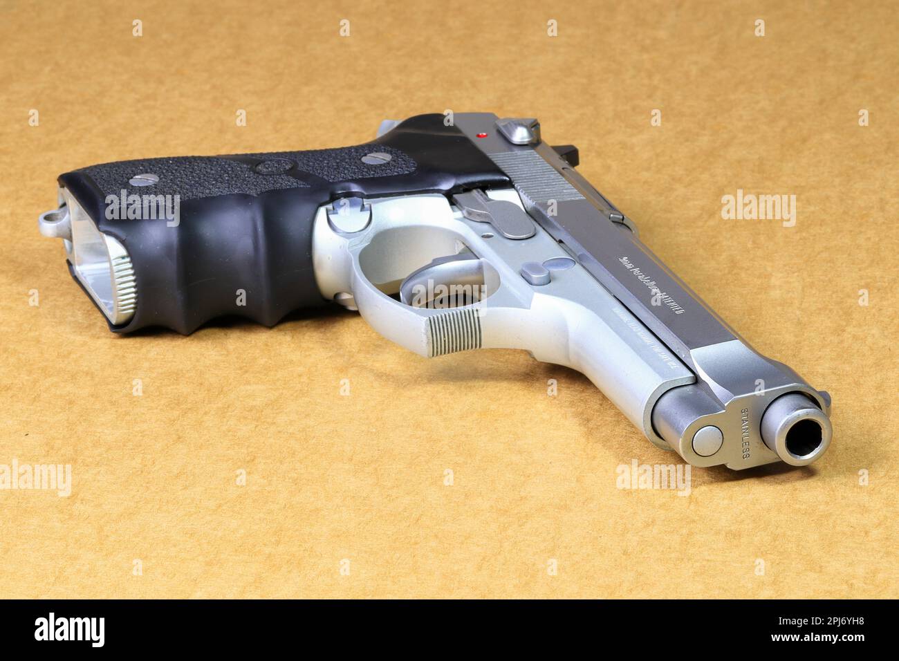 Beretta 92FS, M9 gun on brown paper background. Stock Photo