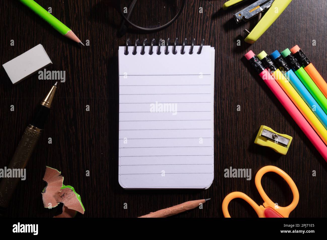 Top view of notepad with stationery products at table Stock Photo - Alamy