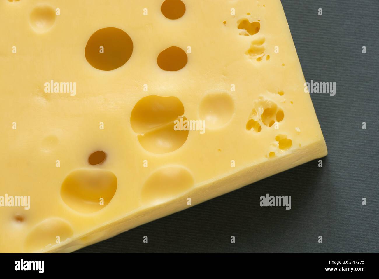 piece of cheese on a gray background close-up Stock Photo