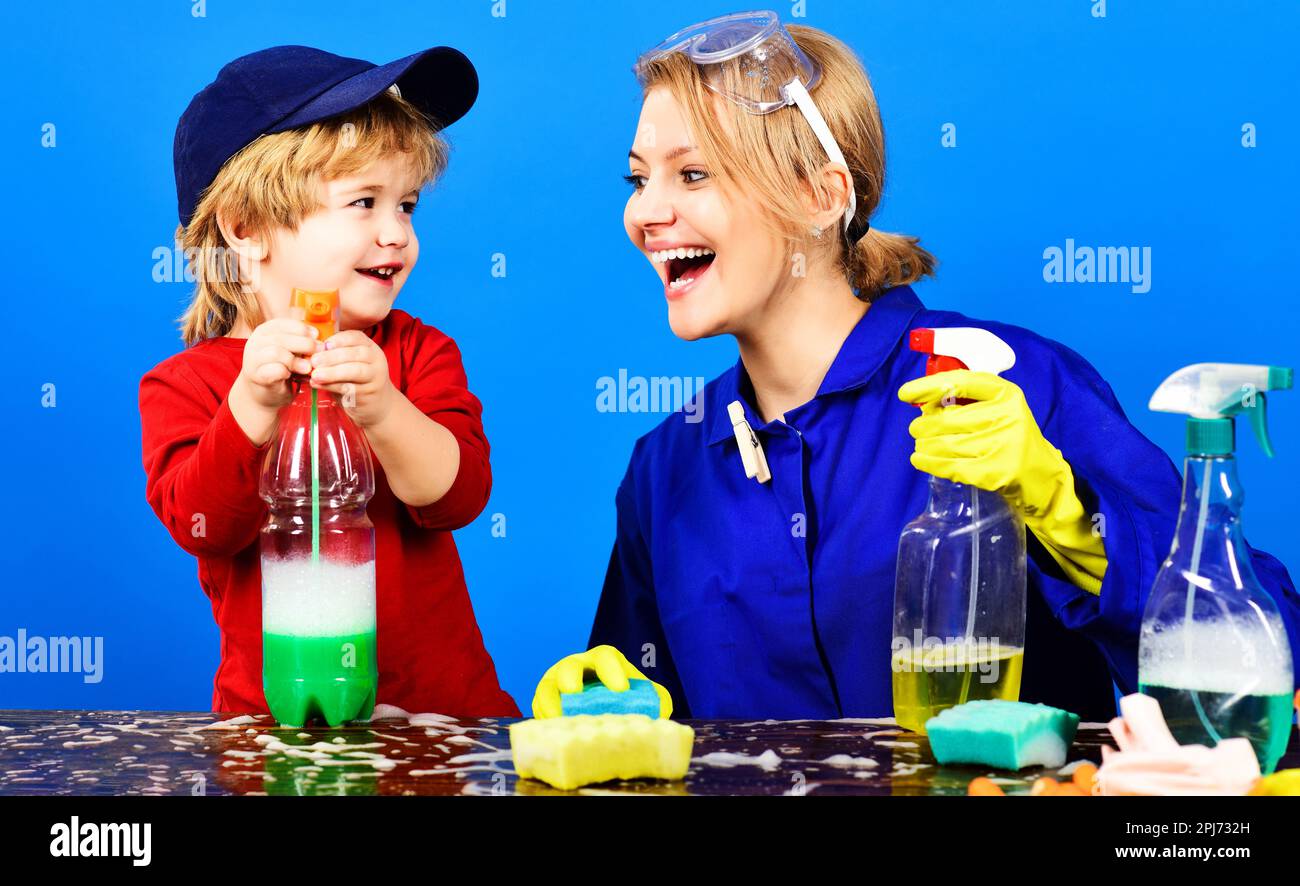 Spring cleaning. Son and mother cleaning home together and having fun. Little child boy and mom with cleaning products. Happy family cleans house Stock Photo