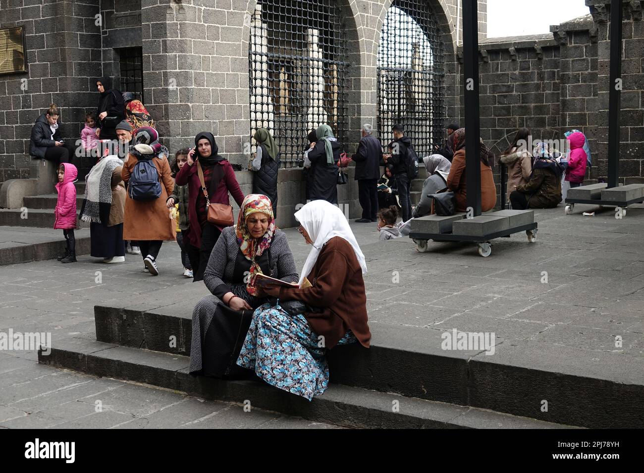A woman is seen listening to another woman reciting the Quran as they visit the shrines in Diyarbakir. The month of Ramadan sees visits to holy places and shrines, praying and making wishes. One of these holy places is the Hazrat Suleyman mosque, which was built in 1150 and is one of the important religious and touristic centers of the world's Muslims. In the garden of the mosque there are shrines of 27 people who died here during the spread of Islam and were said to be descendants of the prophet (Sahaba) Mohammed. Those who visit the shrines, read the Quran, pray and make wishes. (Photo by Me Stock Photo