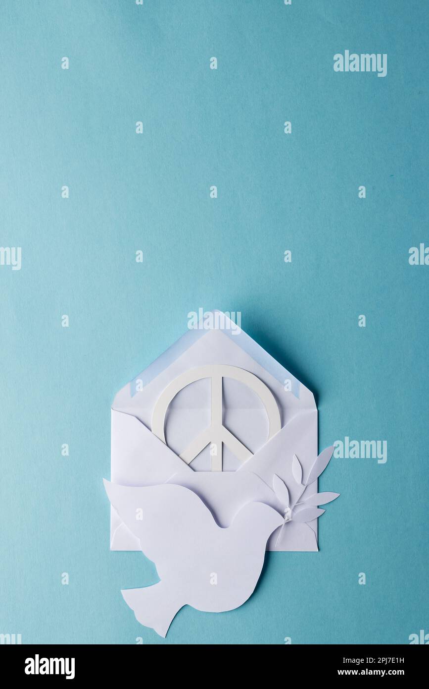 High angle view of white peace sign, white dove and envelope with copy ...