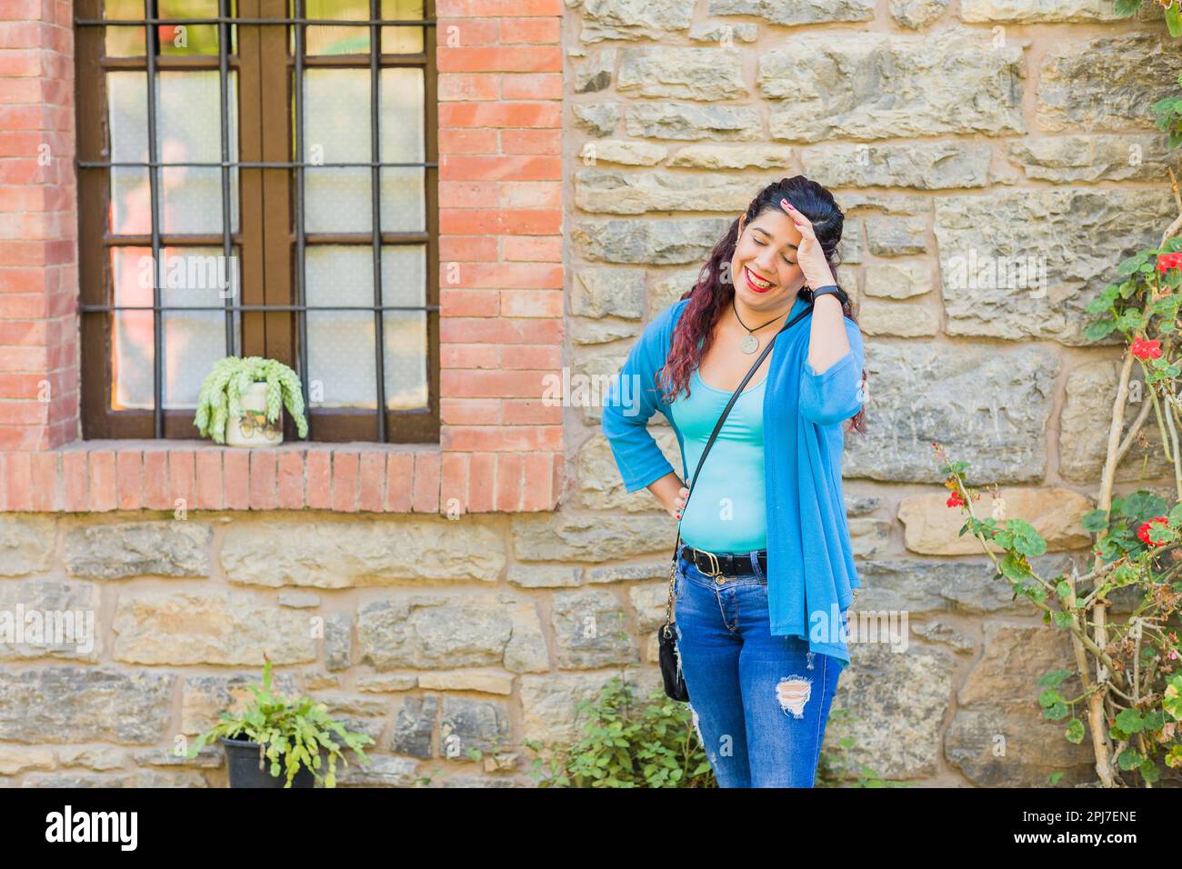 Annoyed and fed up fun emotional expression. Latin woman isolated portrait. Textured wall background Stock Photo