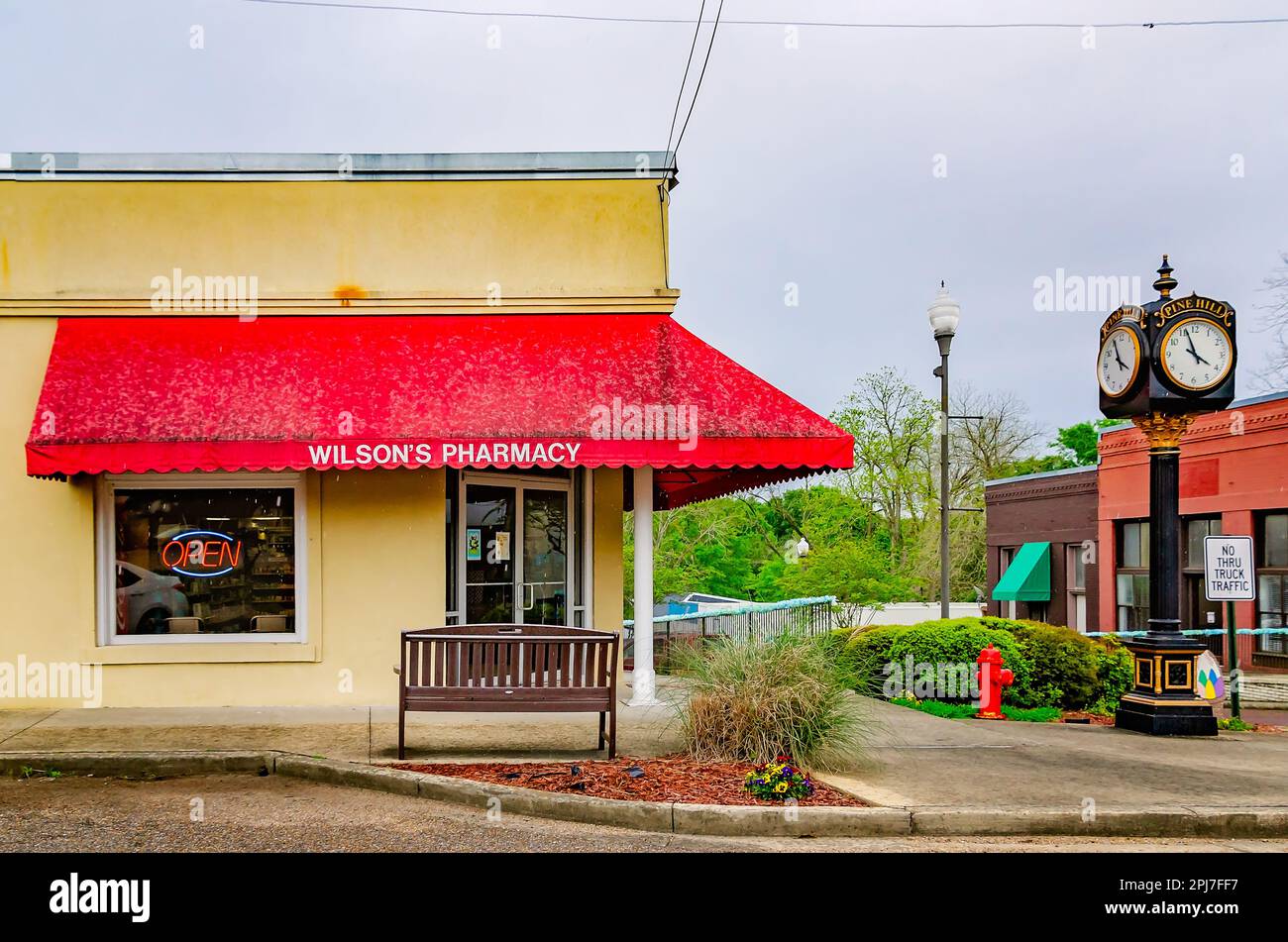 A four-sided post clock stands outside of Wilson’s Pharmacy, March 29, 2023, in Wiggins, Mississippi. The pharmacy was founded in 1924. Stock Photo