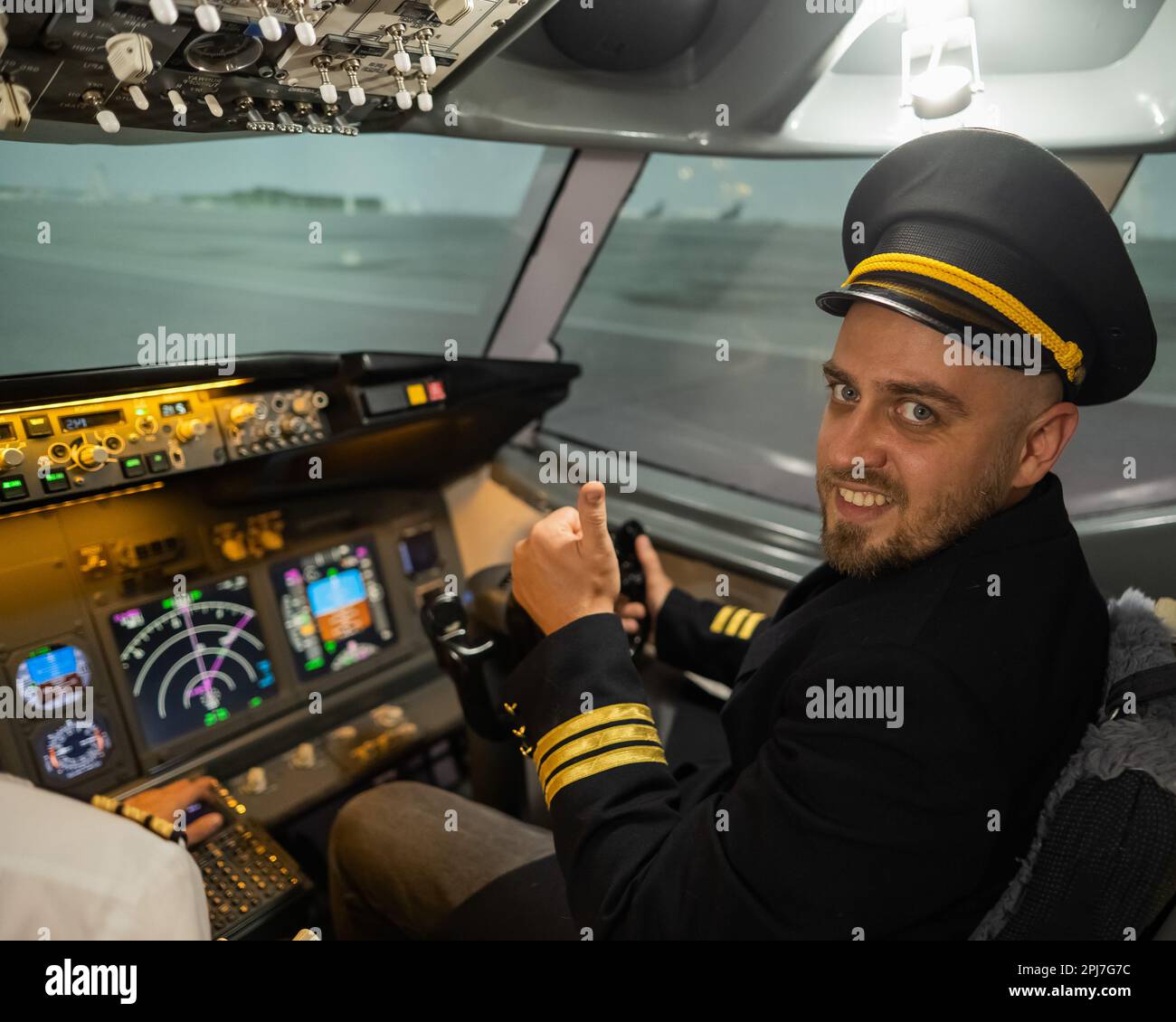 Caucasian bearded man smiling while driving a flight simulator. Pilot ...