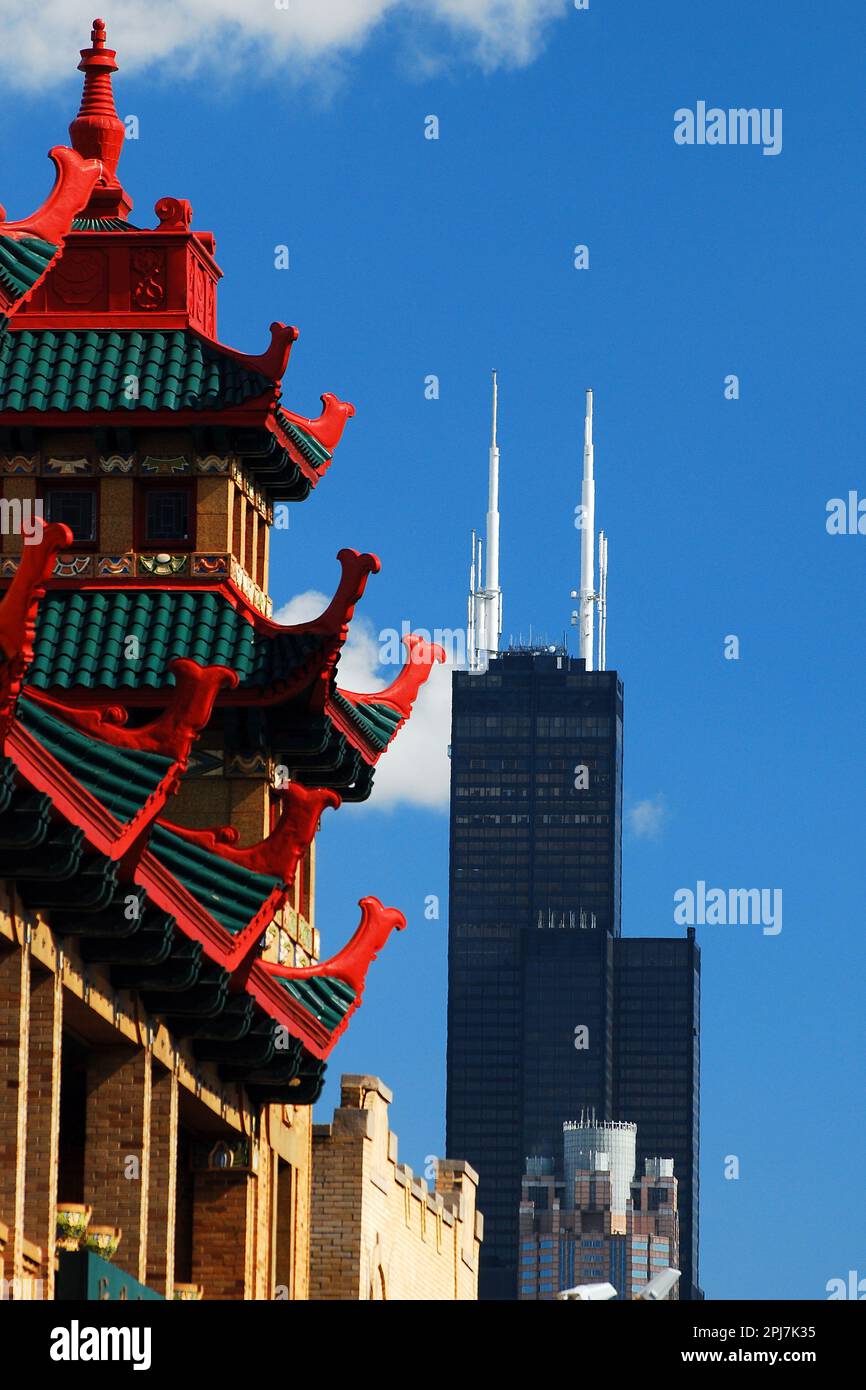 The Asian inspired buildings of Chicago's Chinatown shares the sky with the Willis Tower Stock Photo