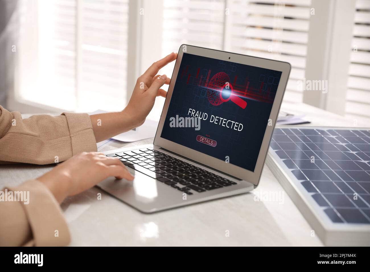 Fraud prevention security system. Woman using laptop at white table, closeup Stock Photo